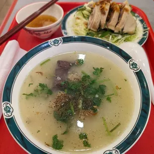 a bowl of soup and a plate of meat