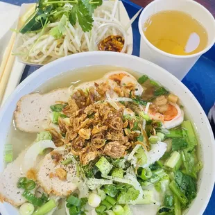 a bowl of noodle soup with chicken and vegetables