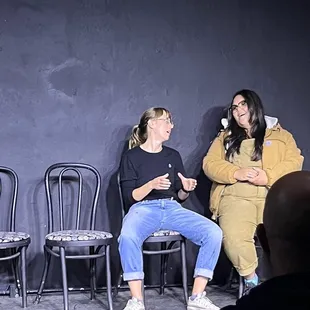 two women sitting on chairs