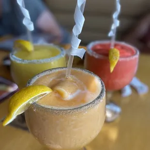 Peach Daiquiri in center Strawberry daiquiri on right  Mango margarita on the left