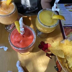 Here we have two virgin daiquiri's one is strawberry and the other is peach and the yellow one is a mango margarita
