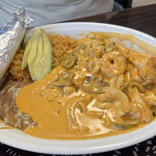Chef Special (always on the menu) grilled chicken, shrimp, onions, jalapeños, and mushrooms, in cream sauce with avocado. rice, &amp; beans