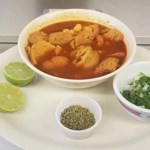 a bowl of soup and a bowl of herbs
