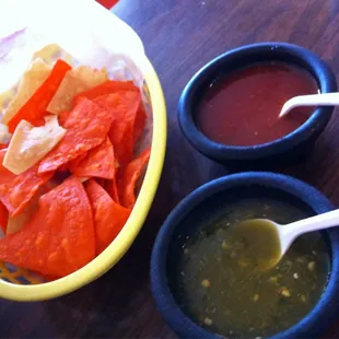 a bowl of chips and a bowl of salsa