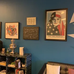 a living room with blue walls and black leather chairs