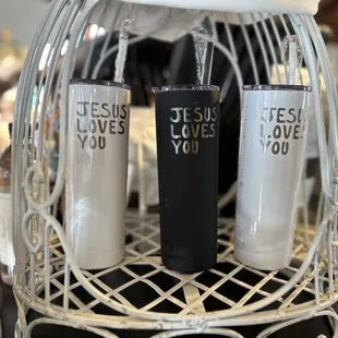 two coffee mugs with jesus loves you written on them