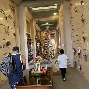 Admiring the tree from distance. Beautiful holiday decorations throughout the building for those in spirit