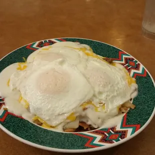 a plate of eggs and hash browns