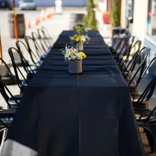 a long table with a vase of flowers