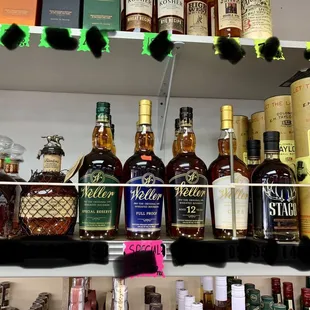a shelf full of liquor bottles