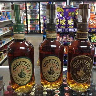 three bottles of different types of liquor