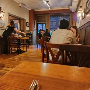 people sitting at tables in a restaurant