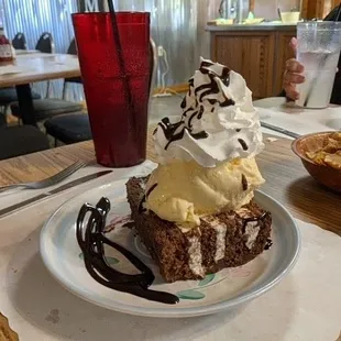 Don&apos;t forget dessert -  HoHo Cake topped with vanilla ice cream, a mound of real whipped cream, drizzled with chocolate sauce
