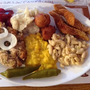 Dressing, fish, corn, pickled okra, mashed potatoes (garlicky), hushpuppies and macaroni &apos;n cheese
