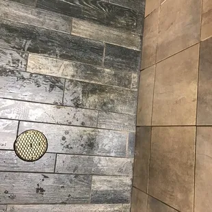 Soaking wet floor in the restroom by the empty paper towel dispenser.