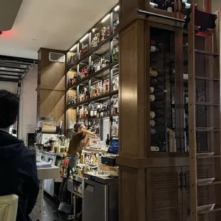 a man standing in front of a bar