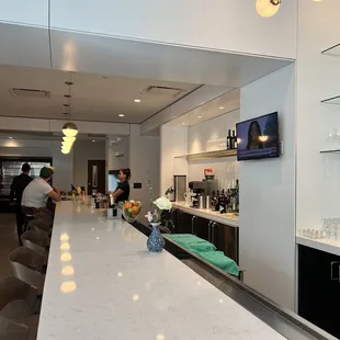 a view of a kitchen with a bar and a television