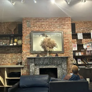 The main seating area with fireplace, books, and a few games.