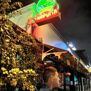 a man standing in front of a restaurant