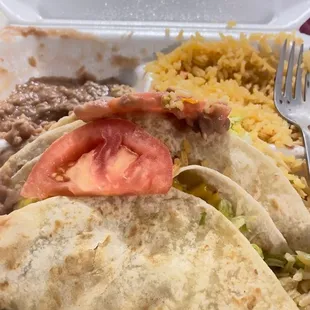 3 beef tacos , beans , and rice