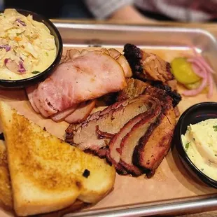a platter of meat and sides