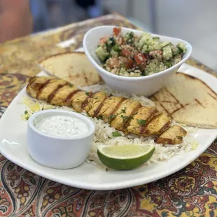 Chicken kabob with rice, pita, and tabouli