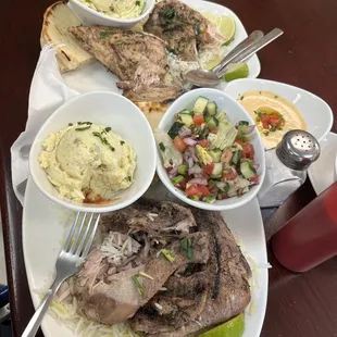 Chicken, rice, Potato salad, salad and hummus. Very nice plating.