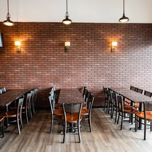 a brick wall and wooden tables