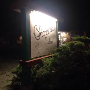 a sign lit up at night