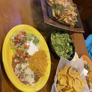 Chicken fajitas for 2, the side plate it comes with (we each got one), guacamole with 2 avocados (maybe too much for 2 people) &amp; chips