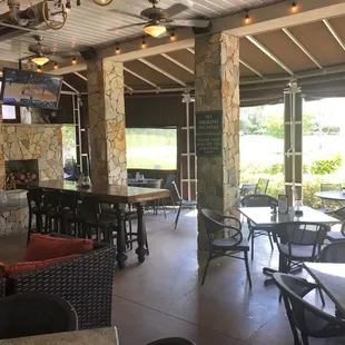 a patio with tables and chairs