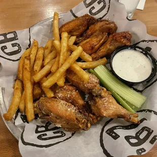 Garlic Parmesan and chipotle bourbon wings with a side of fries and ranch