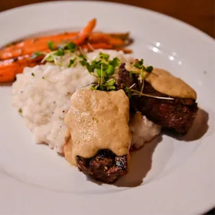 a plate of food with mashed potatoes and carrots