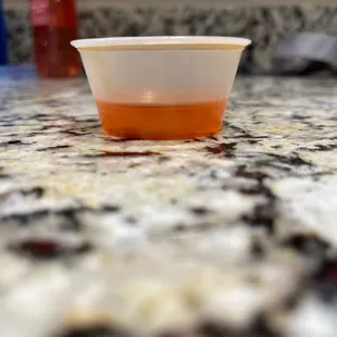 a plastic cup on a marble countertop