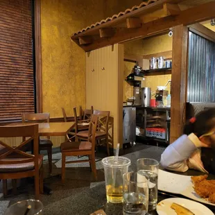 a woman sitting at a table in a restaurant
