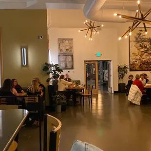 people sitting at tables in a restaurant