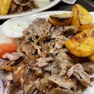 a plate of pulled pork and potatoes