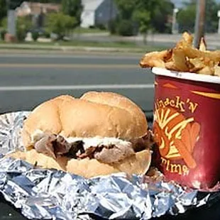 a sandwich and fries on tin foil