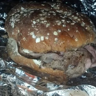 Med rare pit beef on a wheat roll with horseradish, mayo and raw onion