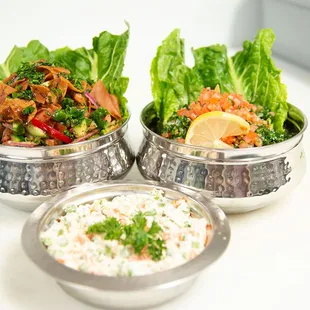 three bowls of food on a table