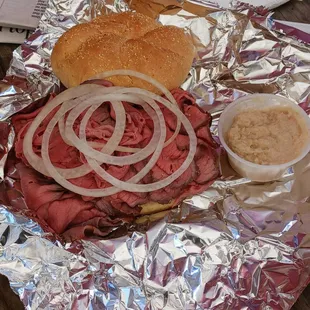 Rare pit beef with raw onions. Horseradish in a cup.