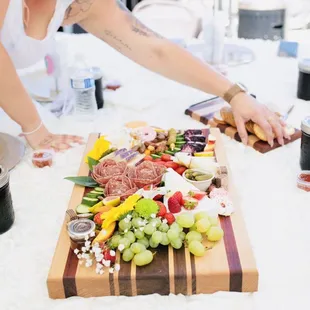 a woman preparing a charcuterie
