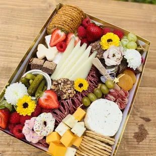 a platter of fruit, cheese, crackers, and crackers
