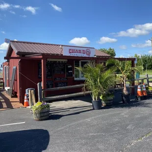 a red building with potted plants