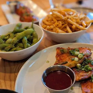 a plate of food with french fries and green beans