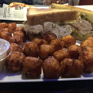 a chicken salad sandwich and tater tots