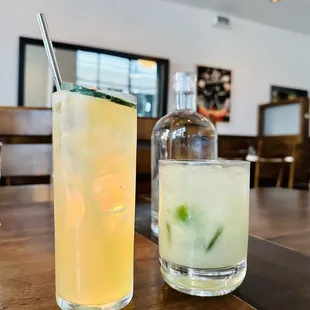 a glass of lemonade and a bottle of gin