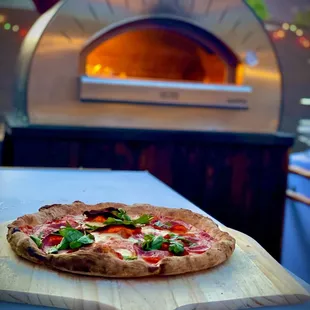 a pizza on a cutting board