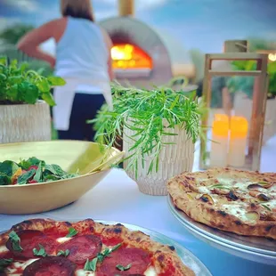two pizzas on a table