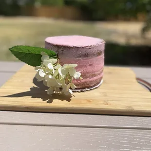 a pink cake with white flowers